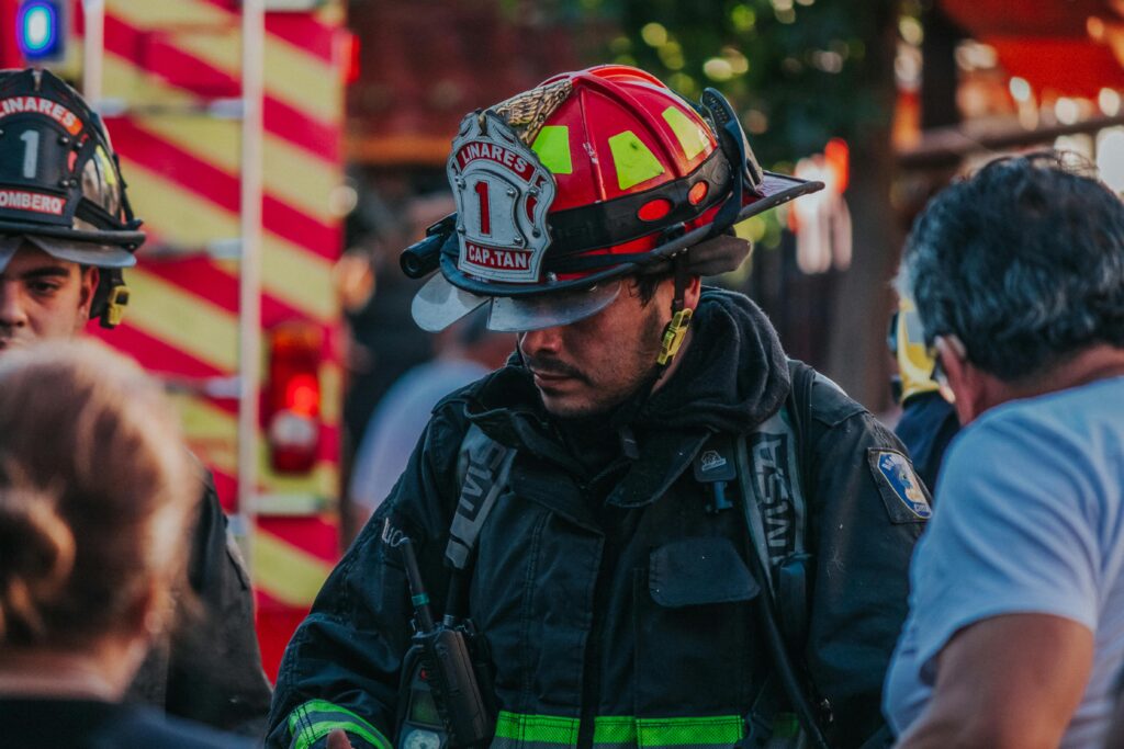 Firefighter in full gear responding to an emergency scene, highlighting the high stress demands faced by first responders